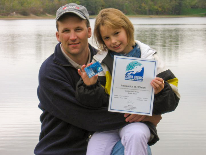 10 year old alex wilson with her dad mitch showing off her junior open water certification